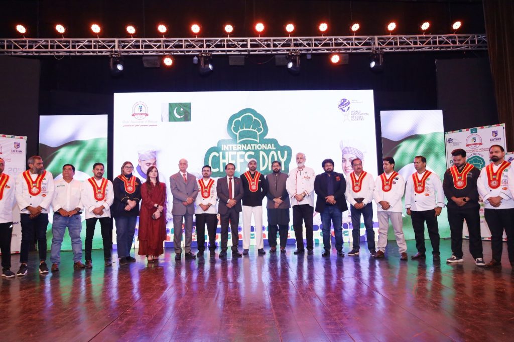 Senior chefs receiving Chef Belt Awards for outstanding culinary achievements