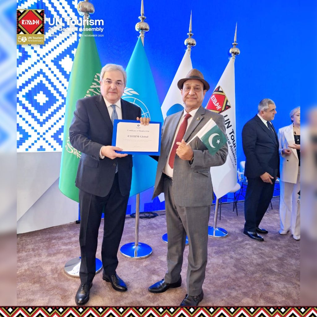 UN Tourism General Assembly stage showcasing global tourism institutions and flags.